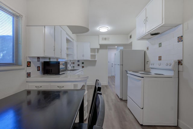 kitchen with tasteful backsplash, visible vents, light wood-style flooring, white appliances, and open shelves