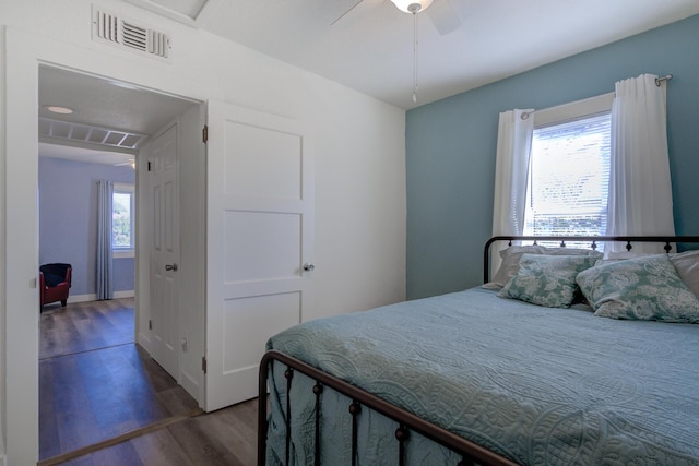 bedroom featuring visible vents, ceiling fan, and wood finished floors