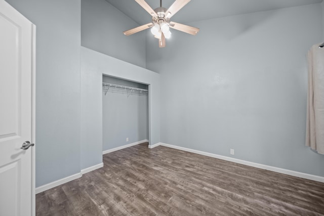 unfurnished bedroom featuring a closet, ceiling fan, baseboards, and dark wood finished floors