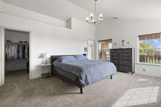 bedroom featuring a spacious closet, carpet flooring, baseboards, and an inviting chandelier