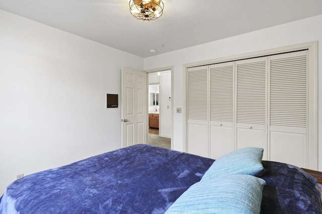 bedroom with a closet and a textured ceiling