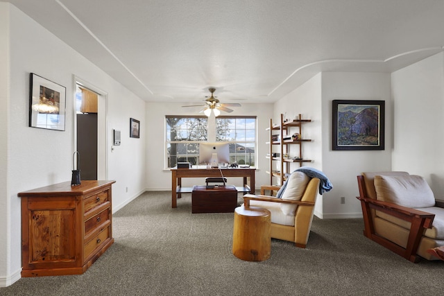 living area featuring carpet, baseboards, and ceiling fan