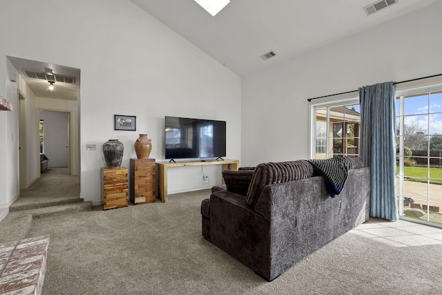 living room with visible vents, high vaulted ceiling, and carpet floors