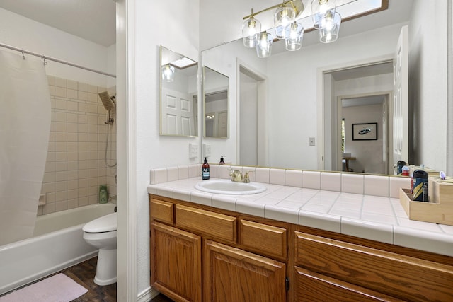 bathroom with toilet, vanity, and shower / tub combo