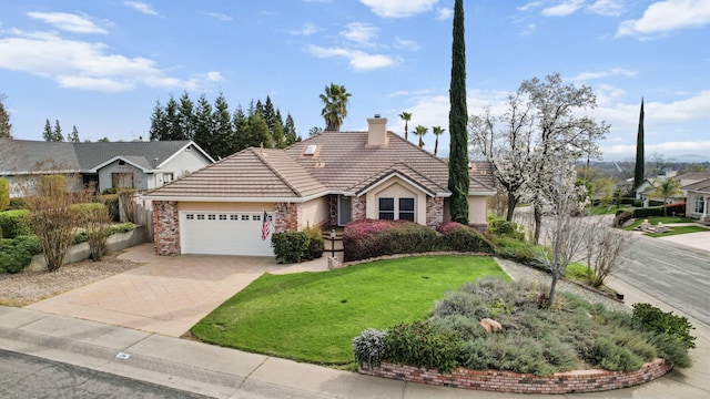 view of front of house featuring a tile roof, decorative driveway, a front yard, an attached garage, and a chimney