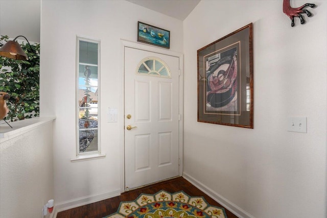 foyer entrance featuring dark wood-type flooring and baseboards