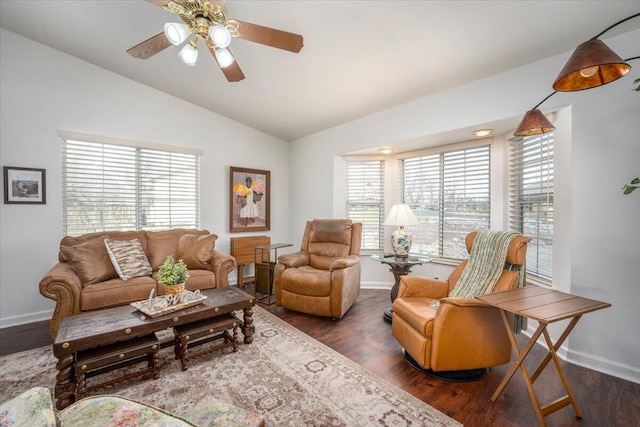 living area with lofted ceiling, wood finished floors, a healthy amount of sunlight, and baseboards