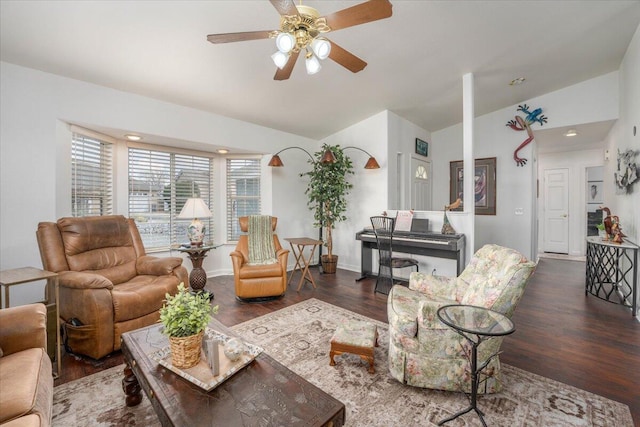 living area featuring ceiling fan, wood finished floors, and vaulted ceiling