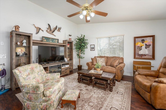 living room with baseboards, dark wood-type flooring, a ceiling fan, and vaulted ceiling