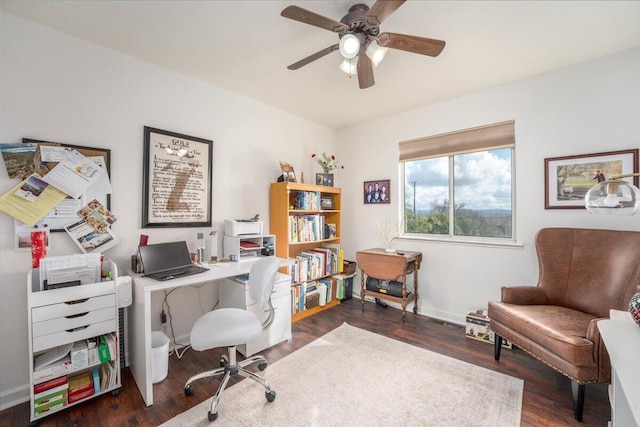 home office with a ceiling fan, wood finished floors, and baseboards