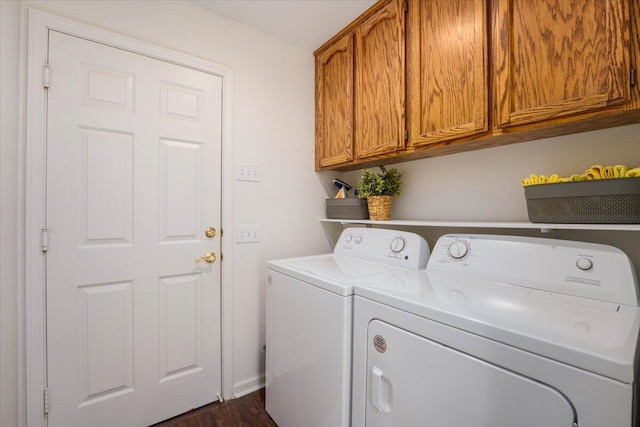 laundry room with baseboards, cabinet space, and washing machine and dryer