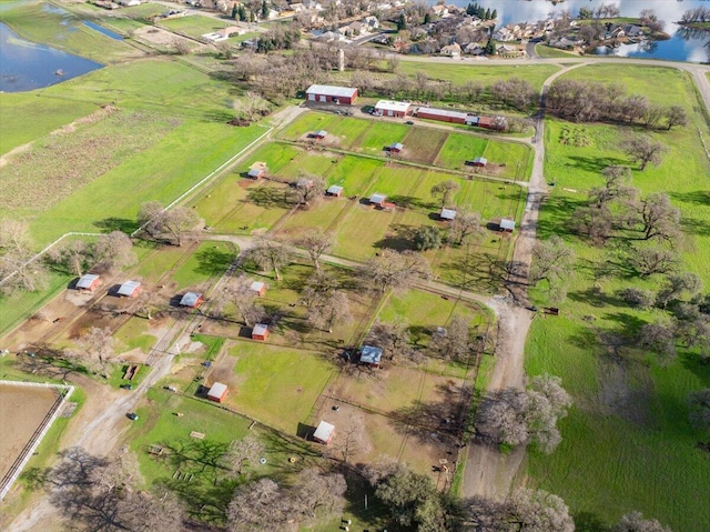 birds eye view of property featuring a water view and a rural view