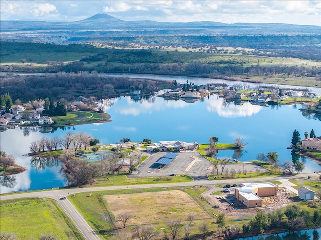 drone / aerial view featuring a water and mountain view