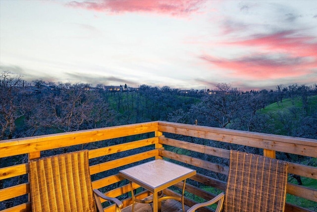 balcony featuring a wooded view