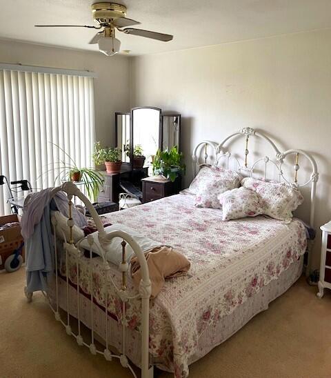 bedroom with ceiling fan and carpet flooring