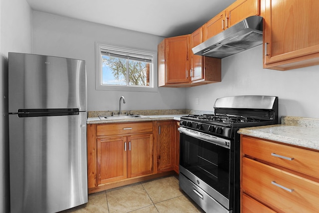 kitchen featuring a sink, appliances with stainless steel finishes, brown cabinets, under cabinet range hood, and light tile patterned floors