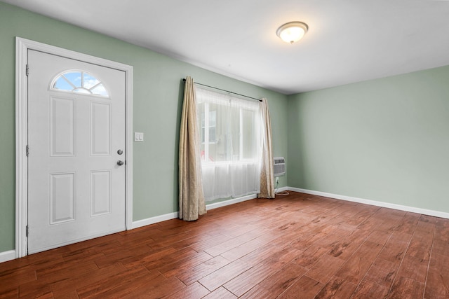 entrance foyer with baseboards and wood finished floors