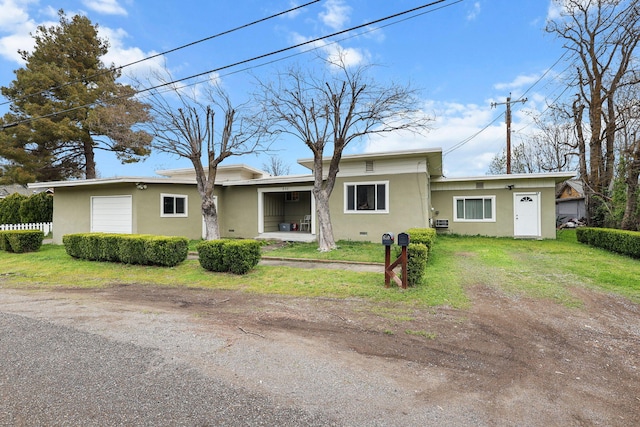 single story home with a front lawn, stucco siding, and an attached garage