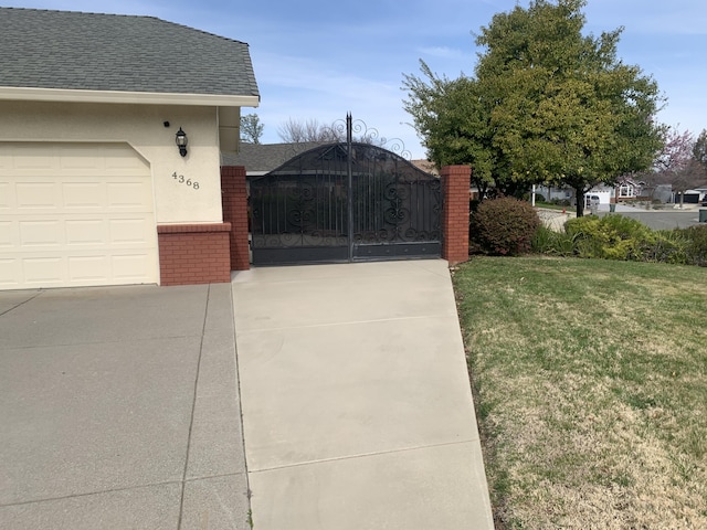 view of gate featuring a lawn