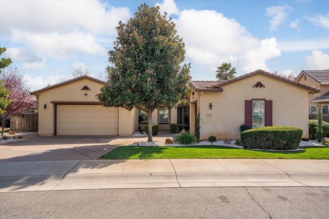 mediterranean / spanish-style house with stucco siding, driveway, a tile roof, fence, and a garage