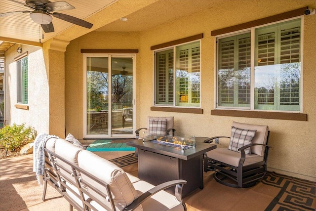 view of patio / terrace with an outdoor living space with a fire pit and ceiling fan