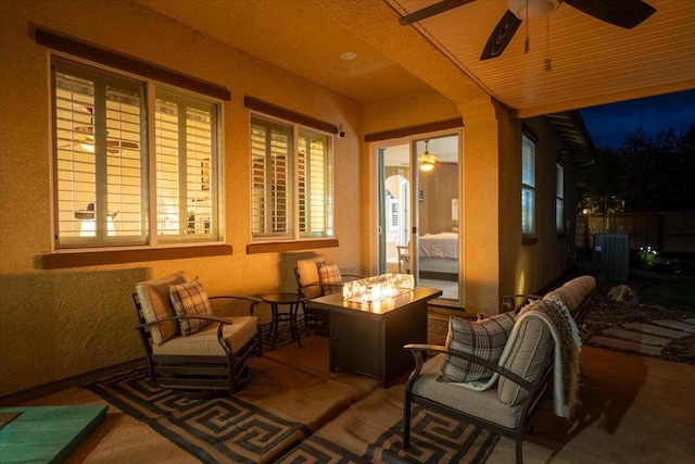 view of patio / terrace featuring central AC unit, an outdoor living space with a fire pit, and ceiling fan