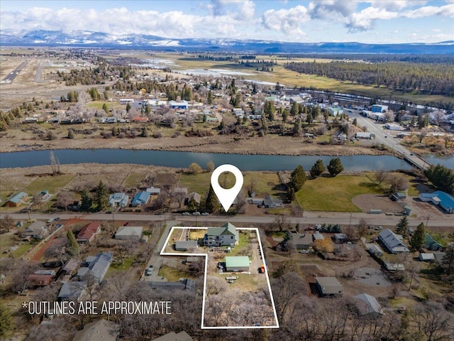 24894 Long St, Fall River Mills, CA 96028 - aerial view of property and surrounding area with property parcel outlined and a water and mountain view