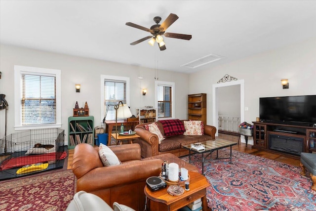24894 Long St, Fall River Mills, CA 96028 - living area featuring healthy amount of natural light, a ceiling fan, and wood finished floors