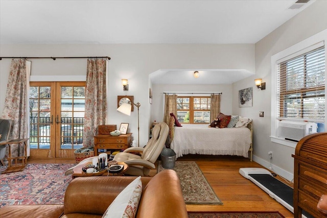 24894 Long St, Fall River Mills, CA 96028 - bedroom with access to outside, wood finished floors, multiple windows, and french doors