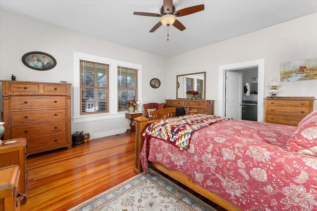 24894 Long St, Fall River Mills, CA 96028 - bedroom featuring wood finished floors, baseboards, ensuite bath, and a ceiling fan