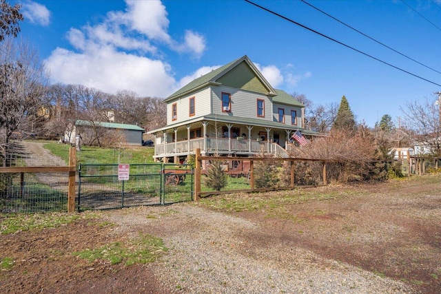 24894 Long St, Fall River Mills, CA 96028 - view of front of house featuring a gate, covered porch, and driveway