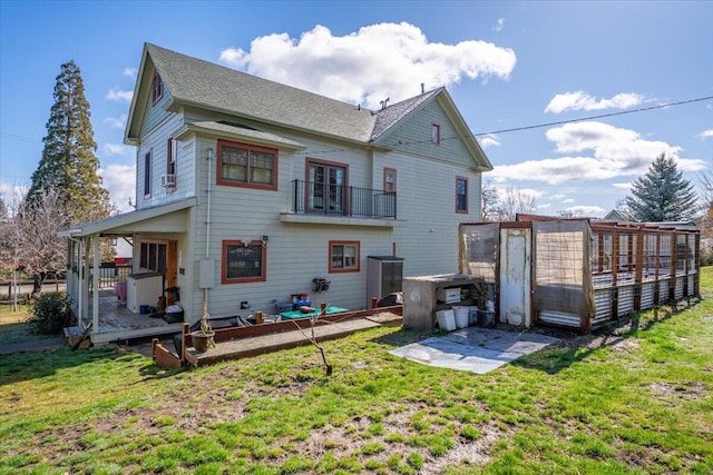 24894 Long St, Fall River Mills, CA 96028 - rear view of property featuring a shingled roof, a lawn, and a balcony