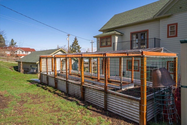24894 Long St, Fall River Mills, CA 96028 - rear view of house featuring a garden, a lawn, roof with shingles, and french doors