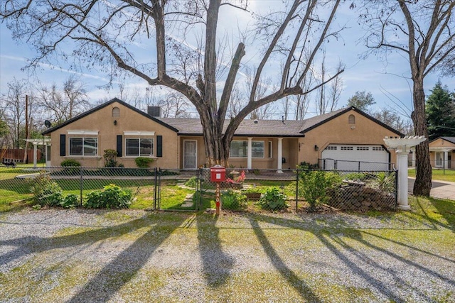 ranch-style house with a fenced front yard, a chimney, driveway, and stucco siding