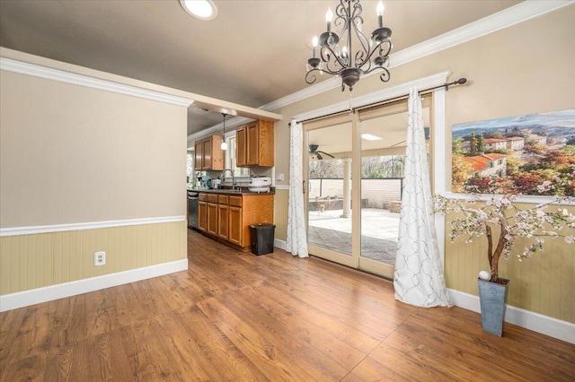 6040 Hornbeck Ln, Anderson, CA 96007 - kitchen with dark wood-type flooring, dark countertops, brown cabinetry, crown molding, and dishwasher
