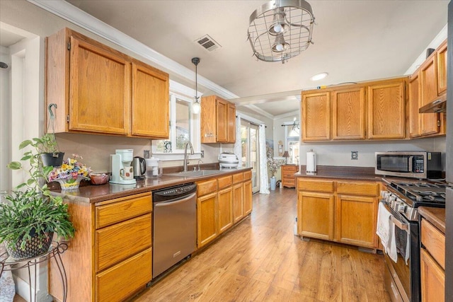 6040 Hornbeck Ln, Anderson, CA 96007 - kitchen with visible vents, a sink, ornamental molding, appliances with stainless steel finishes, and light wood-type flooring
