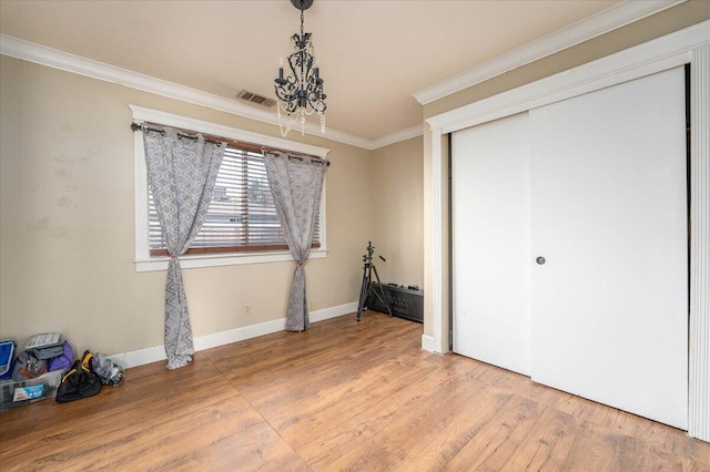 6040 Hornbeck Ln, Anderson, CA 96007 - unfurnished bedroom with visible vents, baseboards, ornamental molding, wood finished floors, and a closet