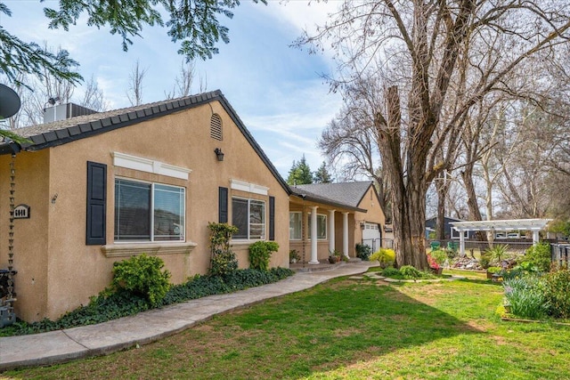 6040 Hornbeck Ln, Anderson, CA 96007 - rear view of house featuring stucco siding, a yard, and fence