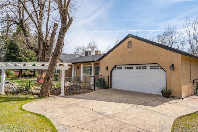 6040 Hornbeck Ln, Anderson, CA 96007 - view of front of home with concrete driveway, fence, a garage, and stucco siding
