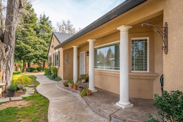 view of property exterior with fence and stucco siding