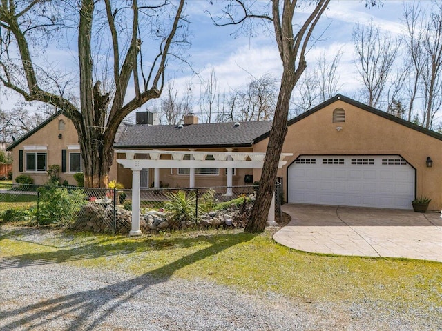 ranch-style house featuring a fenced front yard, an attached garage, driveway, and stucco siding