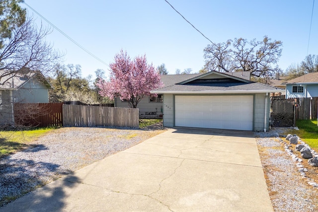 view of front of property with a fenced front yard, a shingled roof, and a gate