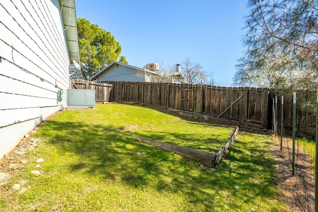 view of yard with a fenced backyard