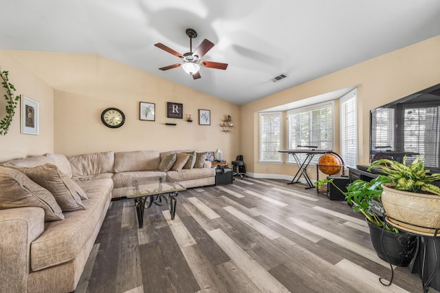 living room with vaulted ceiling, dark wood-style floors, a ceiling fan, and visible vents