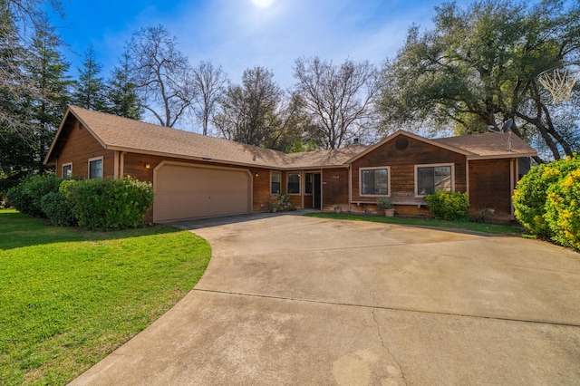 single story home featuring a garage, driveway, and a front yard