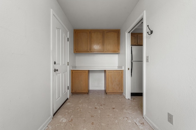 interior space featuring baseboards and light floors