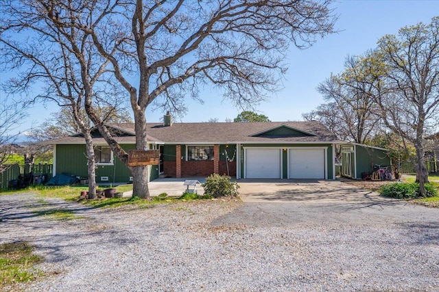 ranch-style home with a garage, brick siding, and concrete driveway