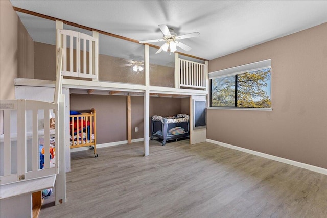 unfurnished bedroom featuring baseboards and wood finished floors