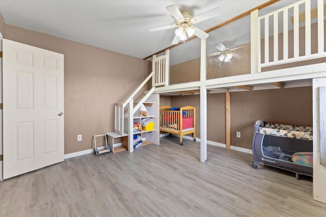 bedroom with baseboards and wood finished floors