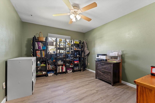 home office featuring ceiling fan, baseboards, and wood finished floors